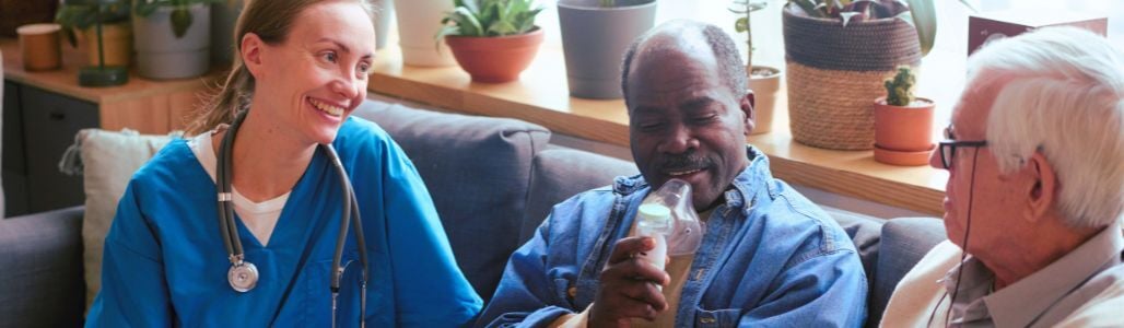 Nurse smiling and talking with patient on oxygen