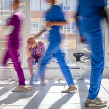 busy hospital hall during spike in need-exhausted nurse.jpg